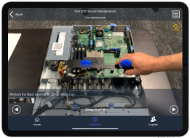 AR Instructor tablet view showing step-by-step overlays on an electronics assembly